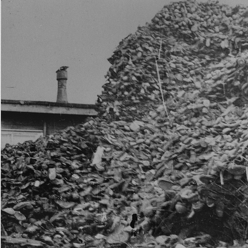 Piles of shoes stored in awarehouse in Auschwitz